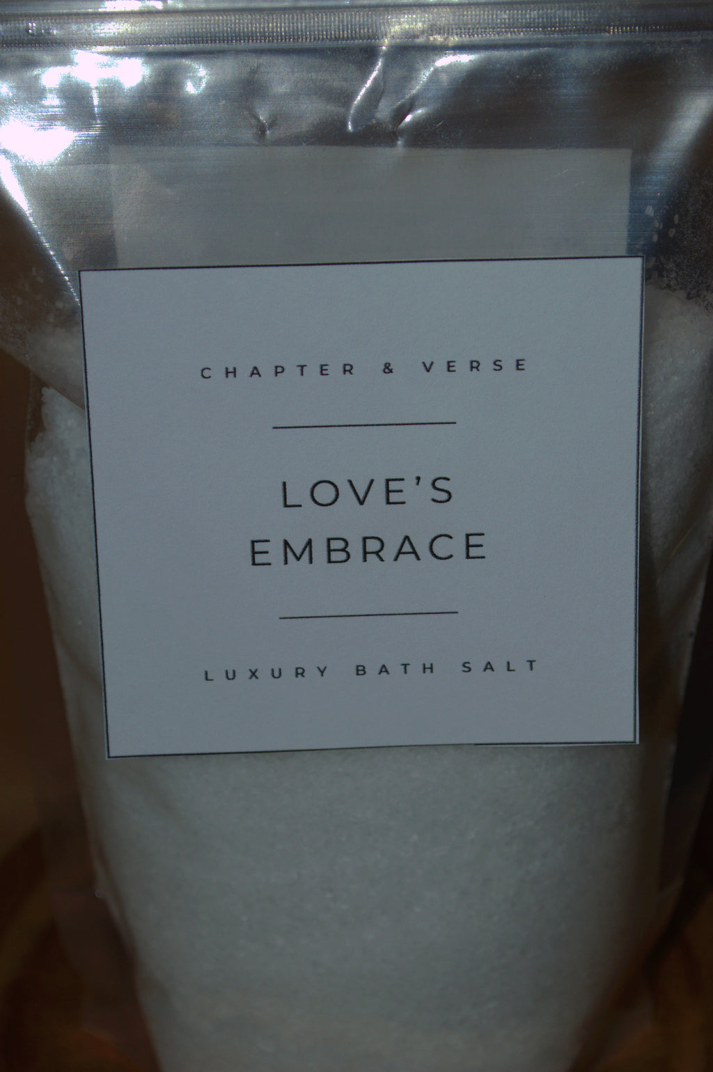 Bath salt packaging with 'Chapter & Verse Love's Embrace' label