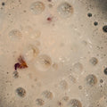 White bath bomb foam with rose petals