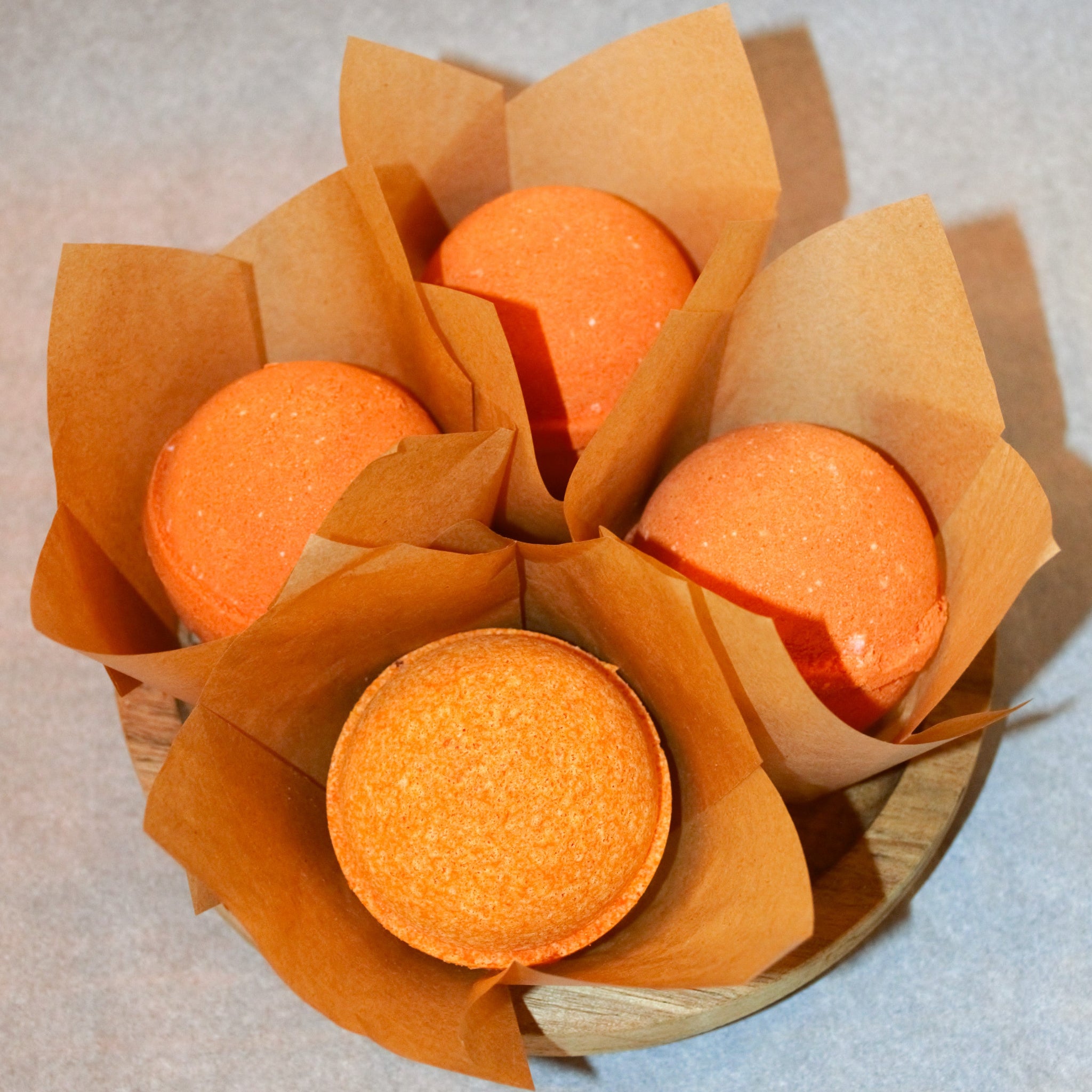 Four pack of 2.5 ounce, sphere shaped orange colored bath bombs.