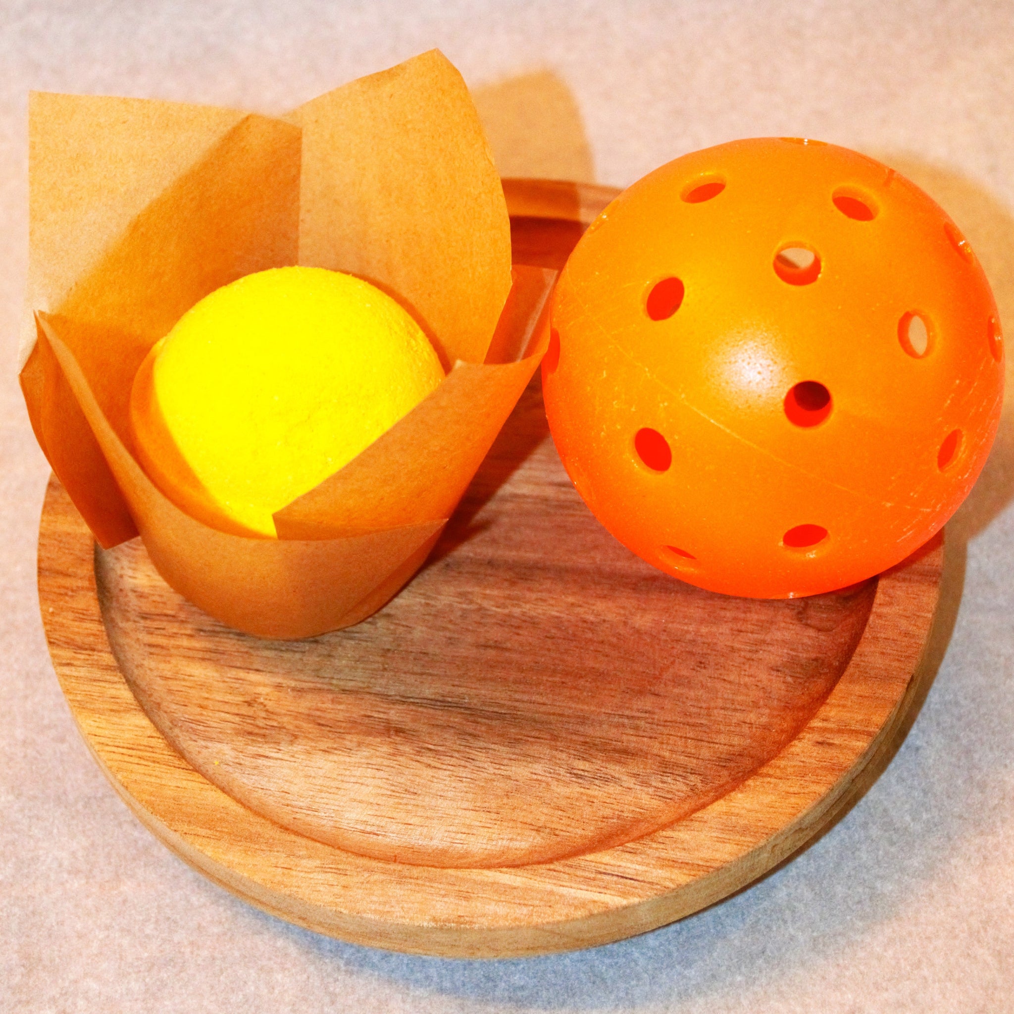 Signature Brazilian Orange and Coconut Bath Bomb size comparison with pickleball