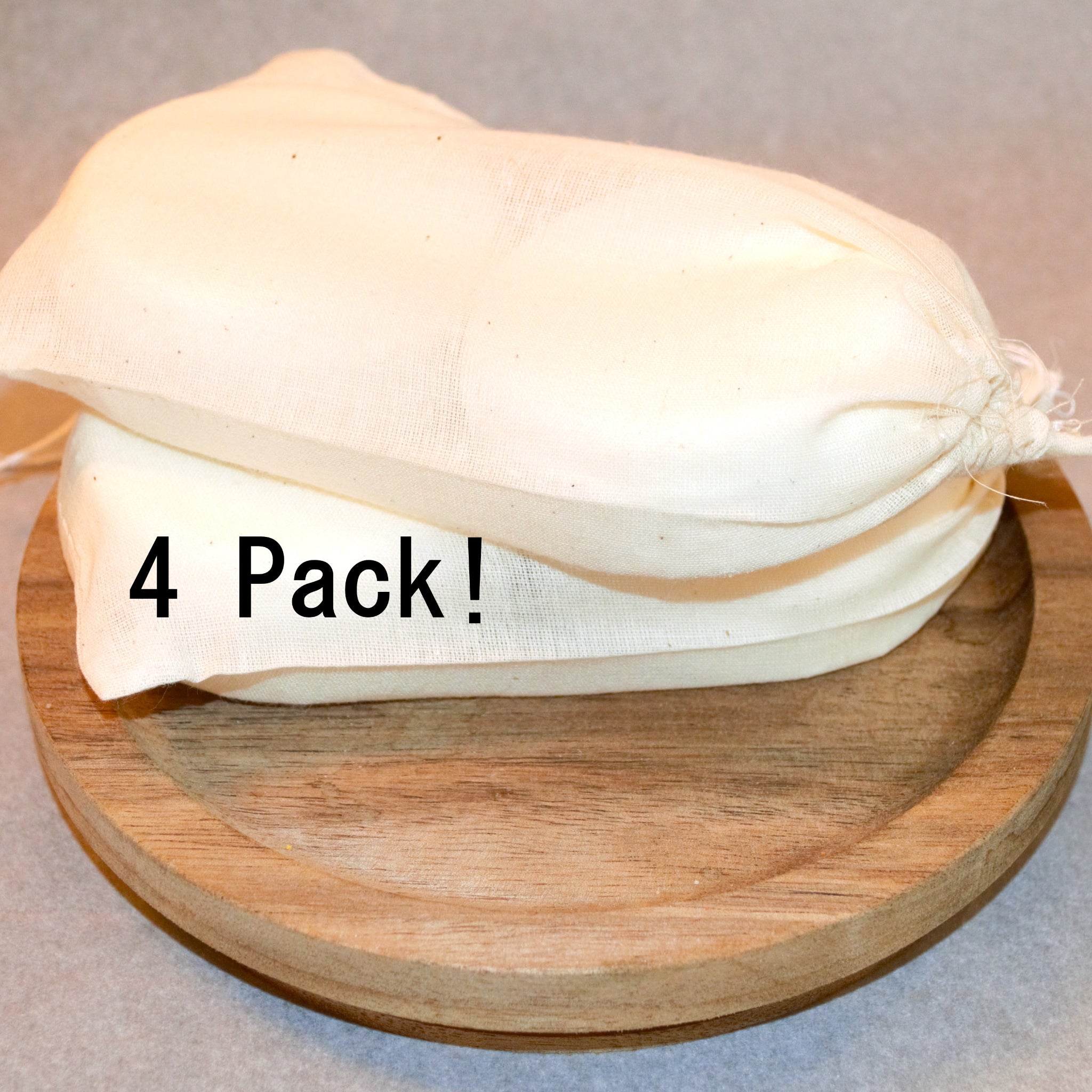 4 pack of handmade shower steamers. Four steamers are distributed among two muslin bags.