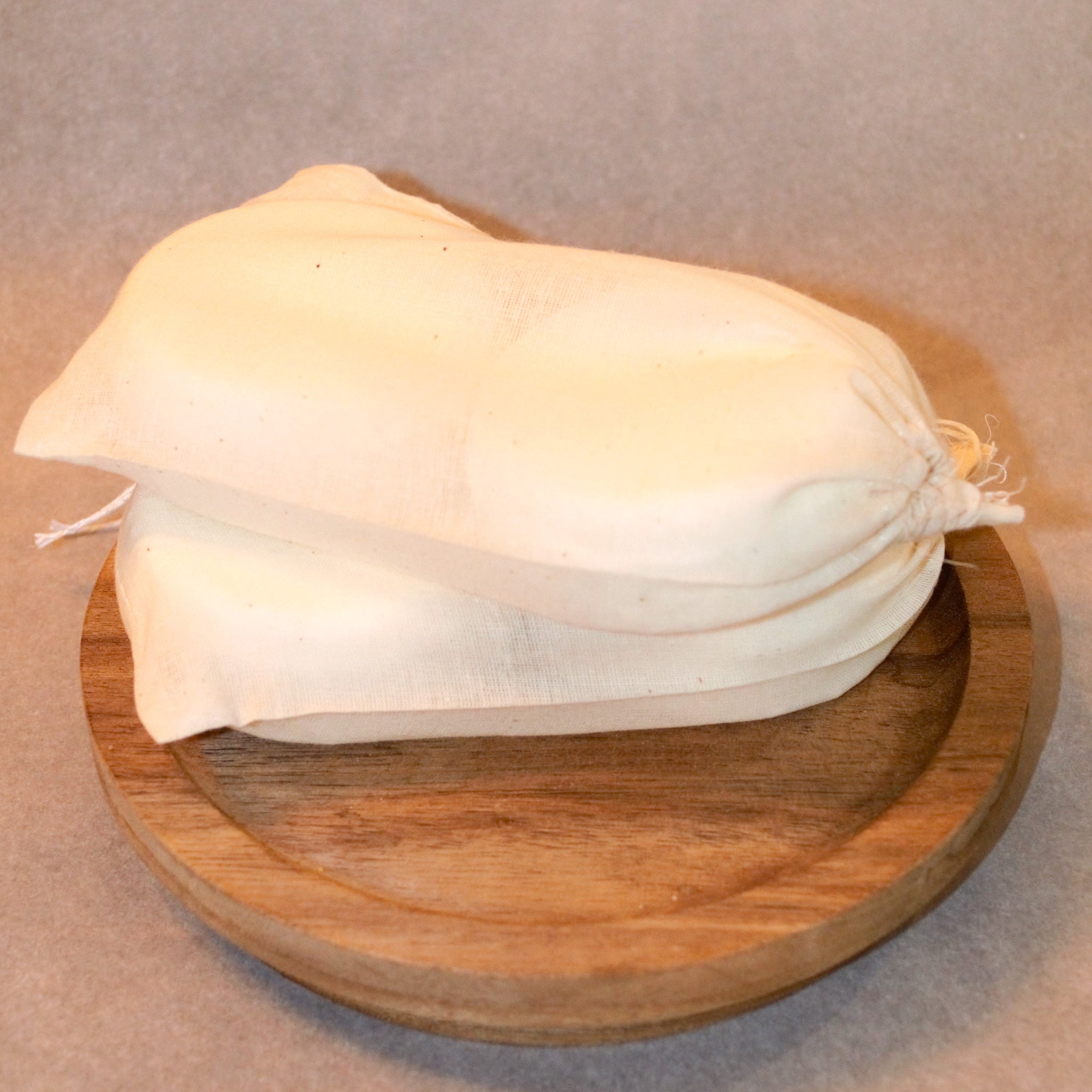 Two muslin bags containing two white, 2.5 ounce shower steamers.
